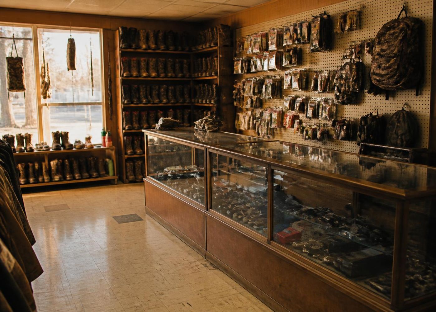 Interior of Holtan's TnC Sporting Goods, with bows and rifles racked along the wall
